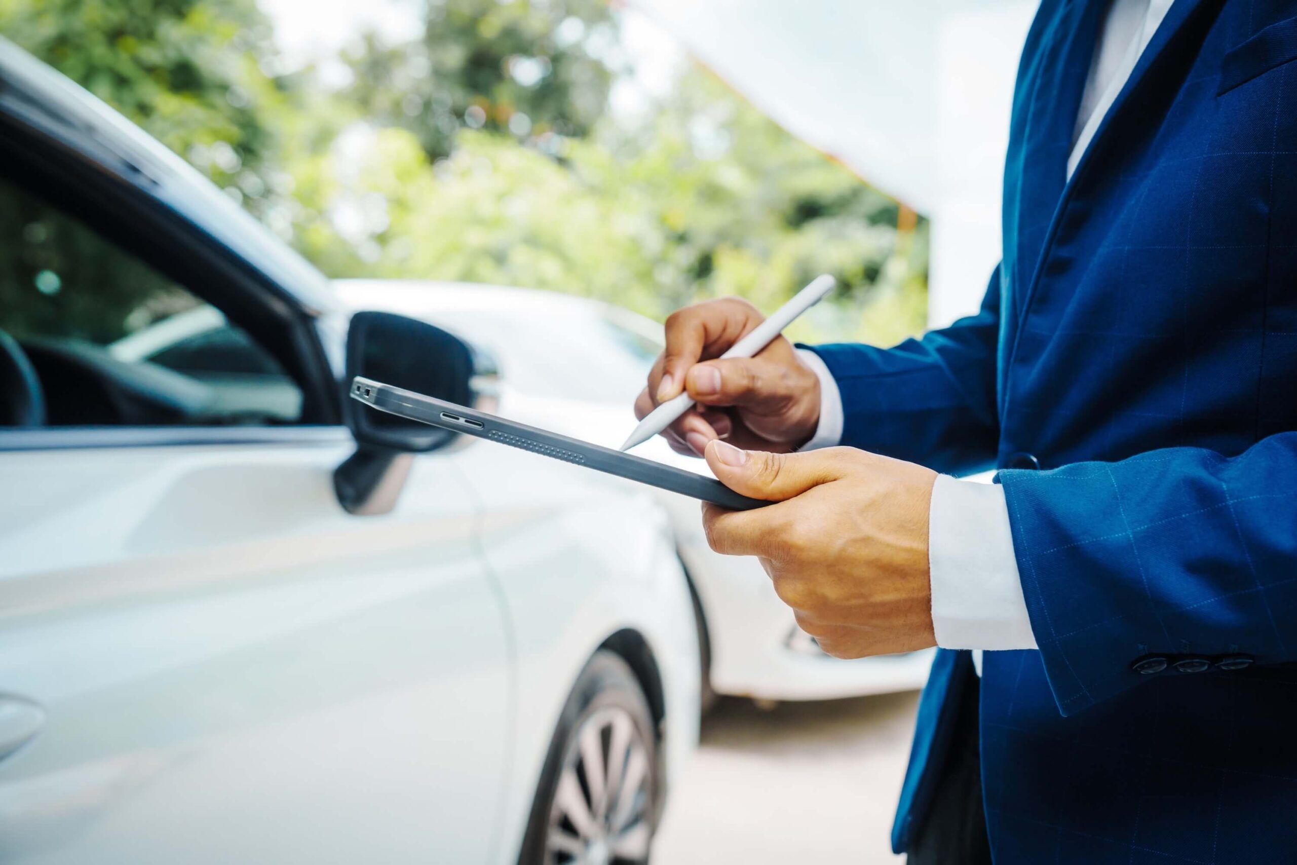 Auto insurance agent assesses the damage to the car